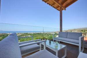 a living room with a couch and a table at Gaea Loft Villa - 1st Floor in Kokkini Khanion