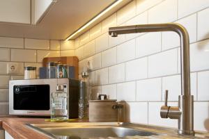 a kitchen counter with a sink and a microwave at Gaea Loft Villa - 1st Floor in Kokkini Khanion +34 photos