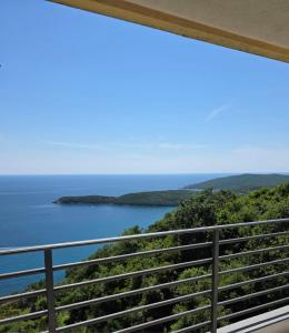 a view of the ocean from the balcony of a house at Apartman Magdalena in Budva +6 photos