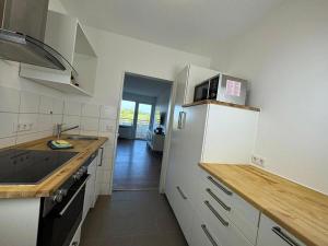 a kitchen with a white refrigerator and a sink at Ferienwohnung BEST VIEW Brilon in Brilon