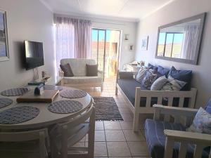 a living room with a couch and a table at Hartenbos - Bayview 230m from beach in Mossel Bay