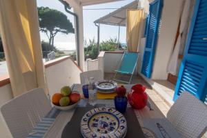 a table with plates of fruit on a balcony at Appartamenti Seccheto in Seccheto +22 photos