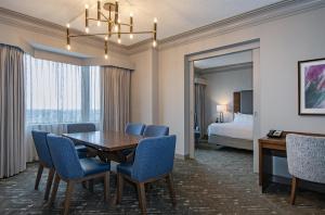 a dining room with a table and chairs in a hotel room at DoubleTree by Hilton West Edmonton in Edmonton +87 photos