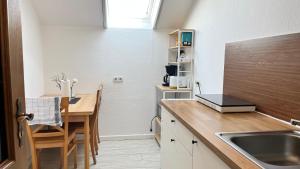 a kitchen with a sink and a wooden counter top at Private Studio Apartment with Balcony in Dortmund-Brackel in Dortmund +8 photos