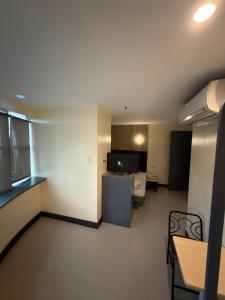a large room with a kitchen and a living room at Nice Hotel Monumento in Manila