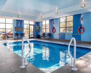 a pool in a hotel room with two swivelling chairs at Comfort Inn in Brockville