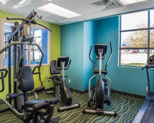a gym with three exercise bikes in a room at Comfort Inn in Brockville
