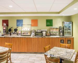 a restaurant with a counter with tables and chairs at Comfort Inn in Brockville