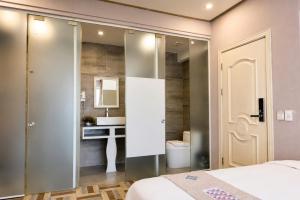 a bedroom with a bed and a bathroom with a sink at Terravia Hotel Sapa Moutain View in Sapa +83 photos