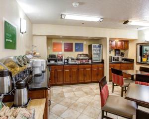 a large kitchen with wooden cabinets and a counter at Comfort Inn Redding Near I-5 in Redding