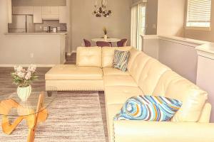 a living room with a white couch and a table at Nyakio Suite in Chesapeake