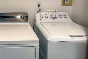 a kitchen with a stove and a washer and dryer at Nyakio Suite in Chesapeake