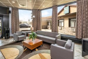 a living room with a couch and a table at Quality Inn & Suites High Level in High Level