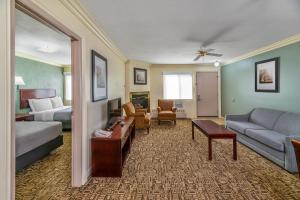 a hotel room with a bed and a living room at Quality Inn & Suites High Level in High Level +53 photos