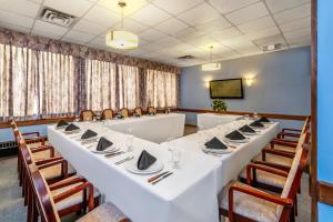 a conference room with a long table and chairs at Quality Inn & Suites High Level in High Level