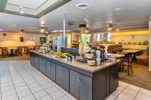 a restaurant with a counter with food on it at Quality Inn & Suites High Level in High Level