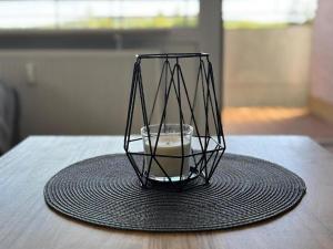a candle in a glass vase on a table at Ferienwohnung BEST VIEW Brilon in Brilon