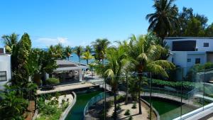 arial view of a resort with palm trees and a pool at Latitude By Horizon Holidays in Rivière Noire