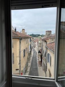a view of a city street from a window at Gîte de la cathédrale in Condom +1 photo