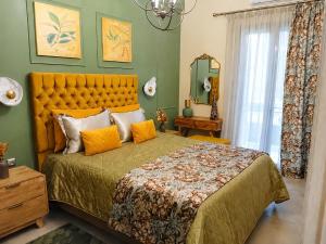 a bedroom with a large bed with orange pillows at Chrysiida Luxury Apt, Stroll to Nafplio Center in Nafplio