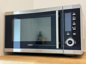 a microwave oven sitting on top of a table at Ferienwohnung BEST VIEW Brilon in Brilon