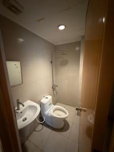 a bathroom with a toilet and a sink at Nice Hotel Monumento in Manila +9 photos
