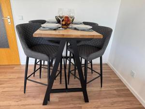 a table with four chairs and wine glasses on it at Ferienwohnung BEST VIEW Brilon in Brilon +25 photos