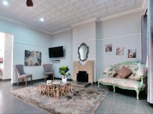 a living room with a couch and a fireplace at Heidelberg Crown Hotel in Heidelberg