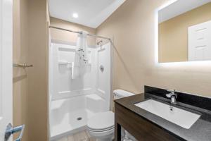 a bathroom with a sink and a shower and a toilet at Suburban Studios Charlotte - Ballantyne in Charlotte +43 photos