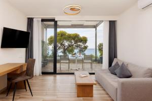 a living room with a couch and a table at Casa Bloo Adults Only by Still Collection in Elia