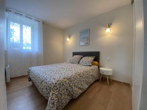 a bedroom with a bed and a window at Maliania in Arbonne