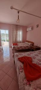 a bedroom with three beds in a room with a window at Yalçın Pansiyon in Silifke