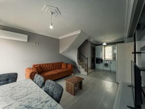 a living room with a couch and a table at Ng Hisar Apart Hotel in Fethiye