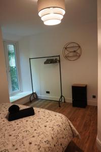 a bedroom with a bed and a large window at Garden flat seafront Hastings in Hastings