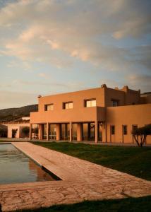 a large building with a pool in front of it at The Riad by Blue Waves in Agadir