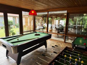 a billiard room with a pool table and a pool table at Virág Vendégház in Hercegkút