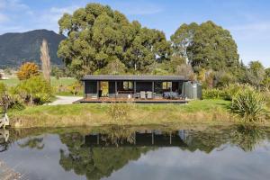 a modern house with a view of a lake at Relaxing Getaway in Pohara in Pohara