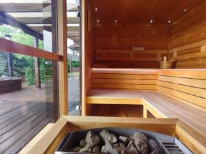 a sauna with a bench and logs in it at Virág Vendégház in Hercegkút