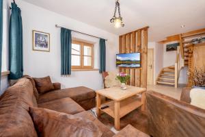 a living room with a couch and a table at Chalet Vogelnest am Waldbach in Reit im Winkl