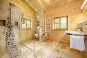a bathroom with a shower and a sink at Chalet Vogelnest am Waldbach in Reit im Winkl +12 photos
