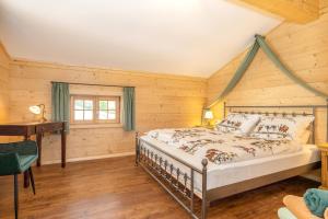 a bedroom with a bed in a room with wooden walls at Chalet Vogelnest am Waldbach in Reit im Winkl
