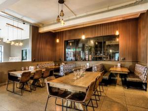 a dining room with wooden tables and chairs at Heidelberg Crown Hotel in Heidelberg