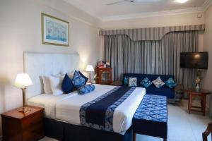 a hotel room with a large bed and a television at Beach Luxury Hotel in Karachi +64 photos