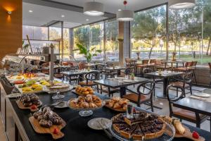 a buffet of food on a table in a restaurant at Elba Almeria Business & Convention Hotel in Almería