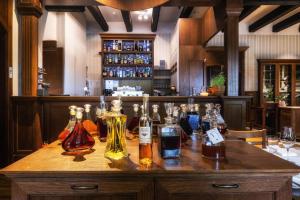 a bar with a bunch of bottles on a table at Resort Dworzysko in Szczawno-Zdrój +105 photos