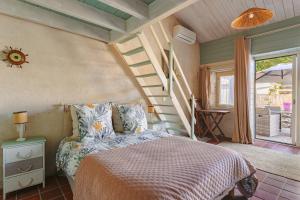a bedroom with a bed in a room with stairs at Mimosa in La Jarrie