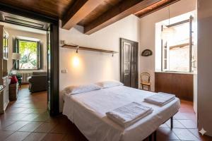 a bedroom with a bed with two towels on it at Terrace with a view! in Moltrasio