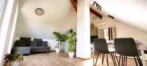 a living room with a couch and a table and chairs at Špulka Hideaway - Romantic Forest Escape near Prague in Teplýšovice