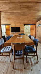a dining room with a large wooden table and chairs at ShodaView in Oni
