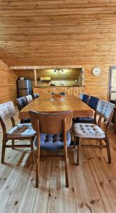 a wooden dining room with a table and chairs at ShodaView in Oni